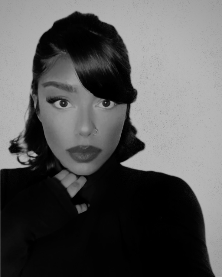 Black and white photo of Saana in a black turtle neck. 